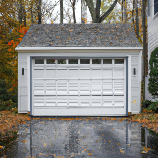 Residential garage door on a Cranford, NJ driveway in late autumn with leaves at the threshold and visible hardware.