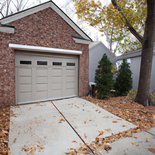 Suburban Cranford driveway with modern closed two-car garage door, brick facade and autumn trees, wide-angle view